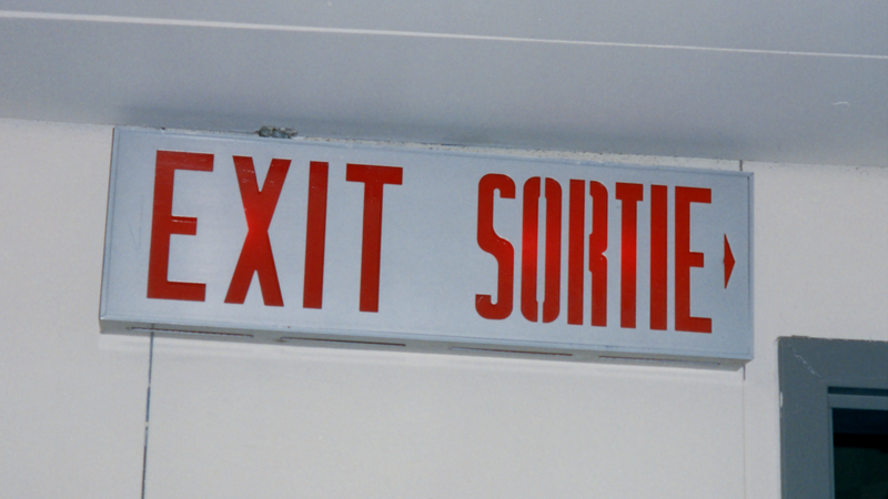 Sign that reads exit in English and French